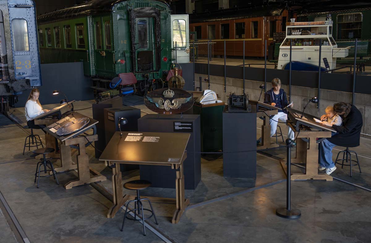 Visitors drawing in the Train World exhibition
